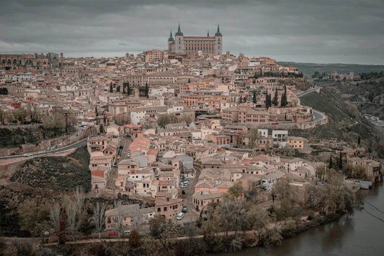 a city surrounded by mountains with a river running through it