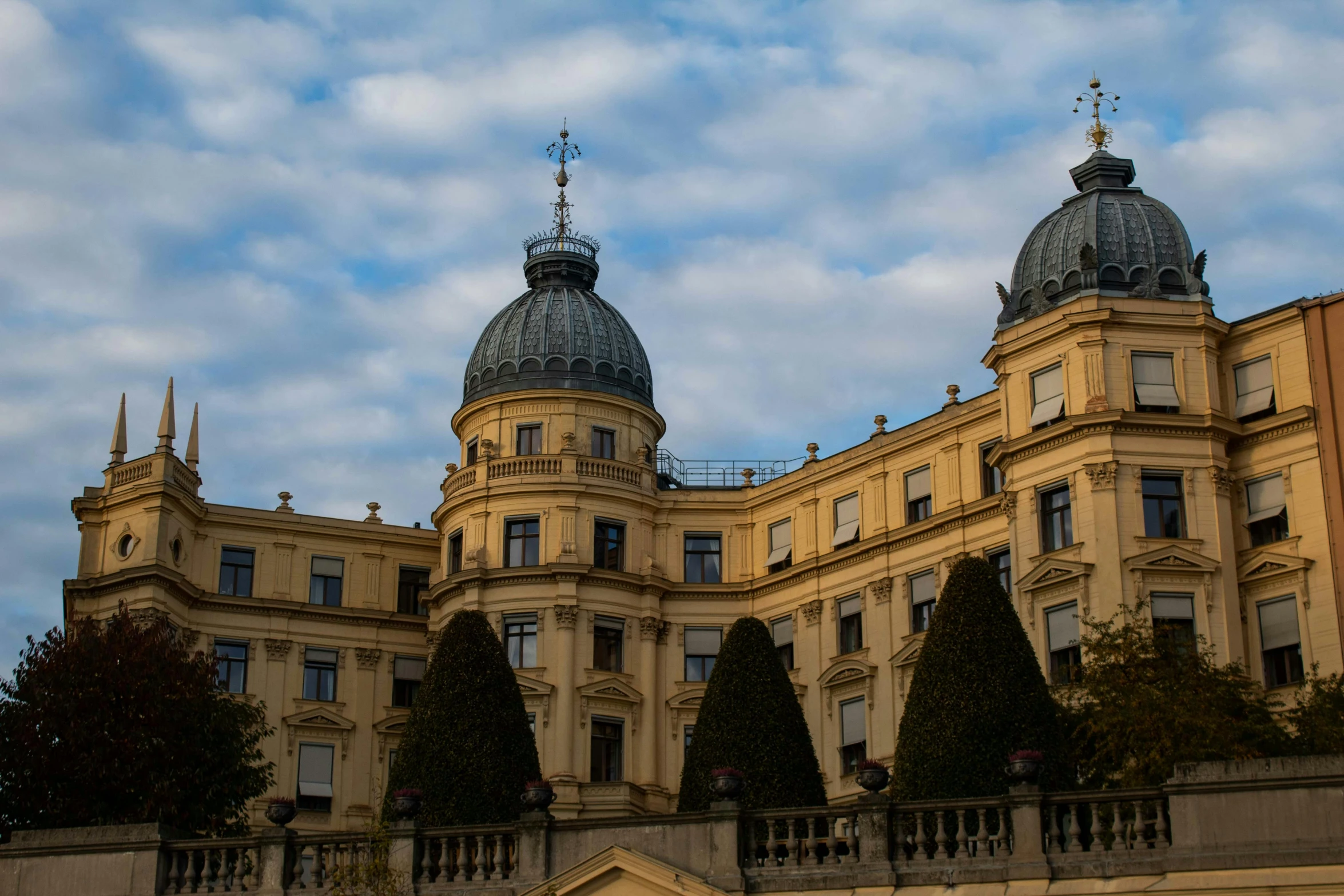 two large towers with top tops on an old building