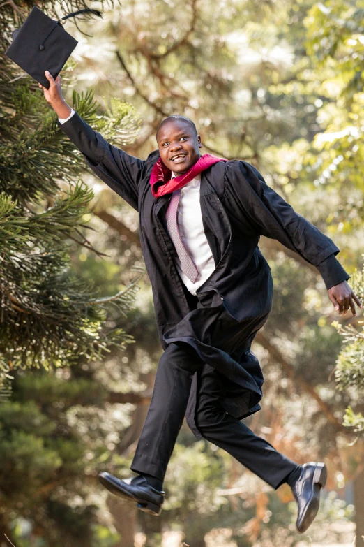 a man is leaping up into the air with his book in hand