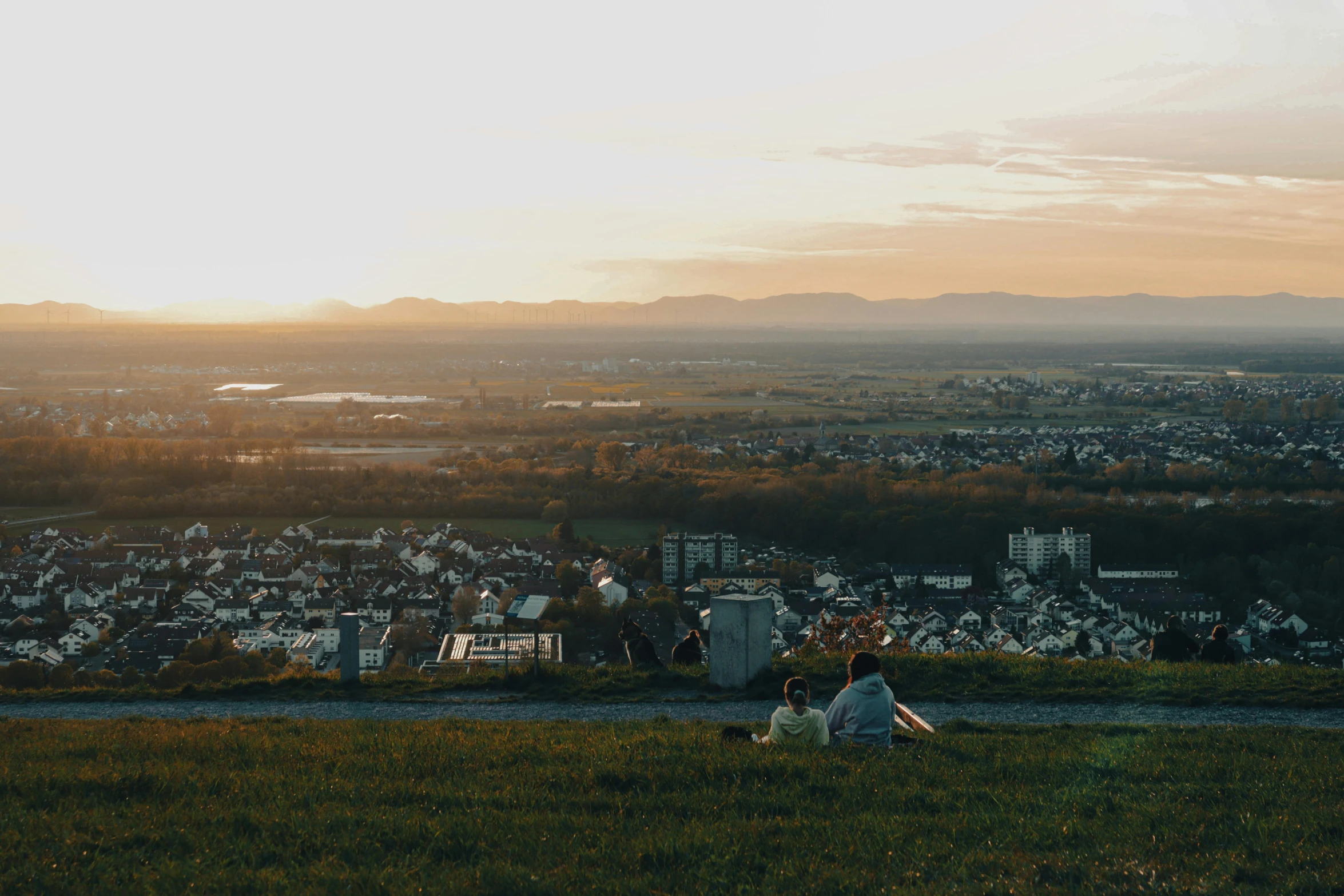 the person is sitting next to each other near a city