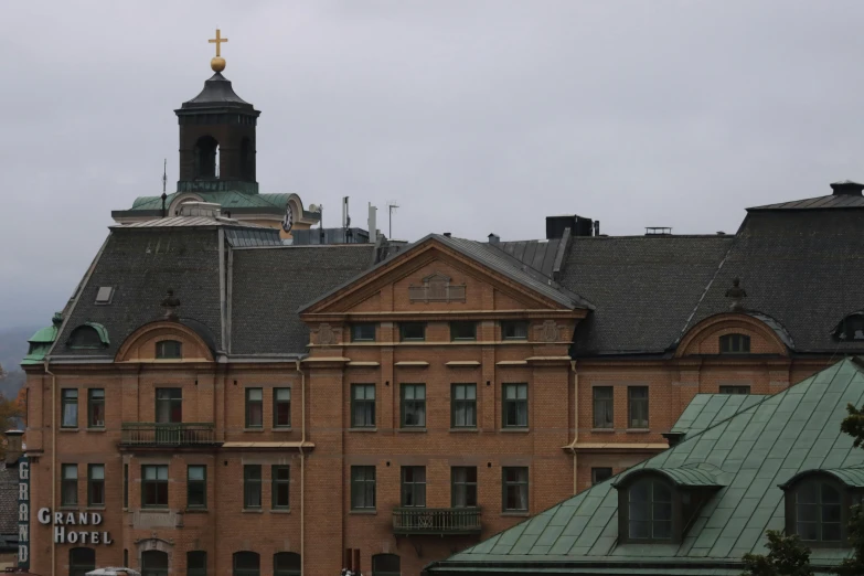 an old building with a steeple and a clock on the top of it