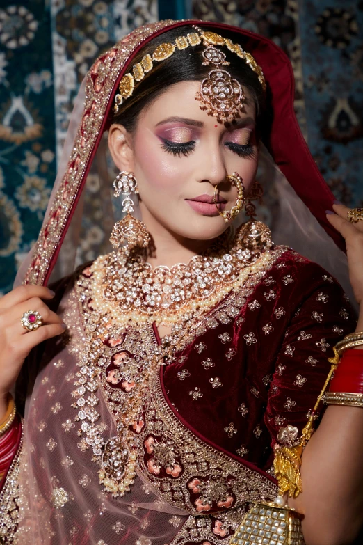 a bride wearing a bridal gown and veil, posing for the camera