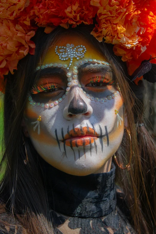 a woman with sugar makeup has flowers in her hair