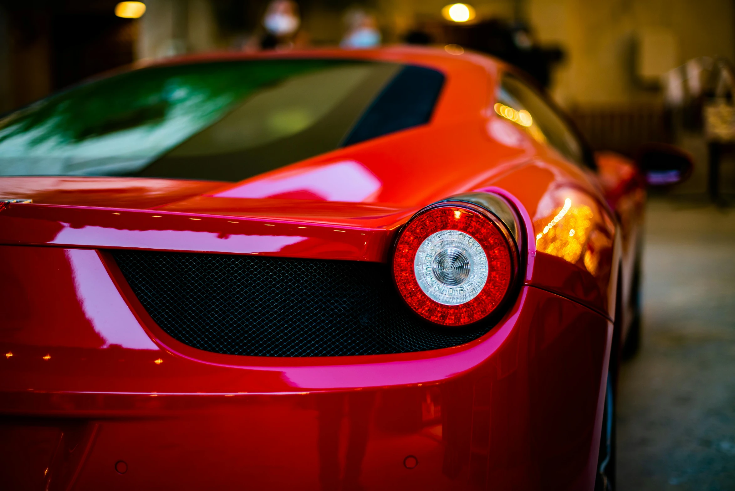 a red car parked inside of a garage