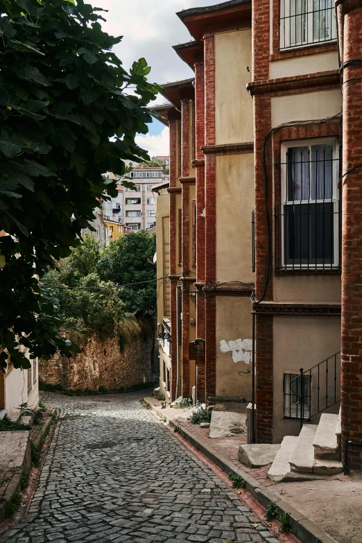 an alley between brick and concrete buildings