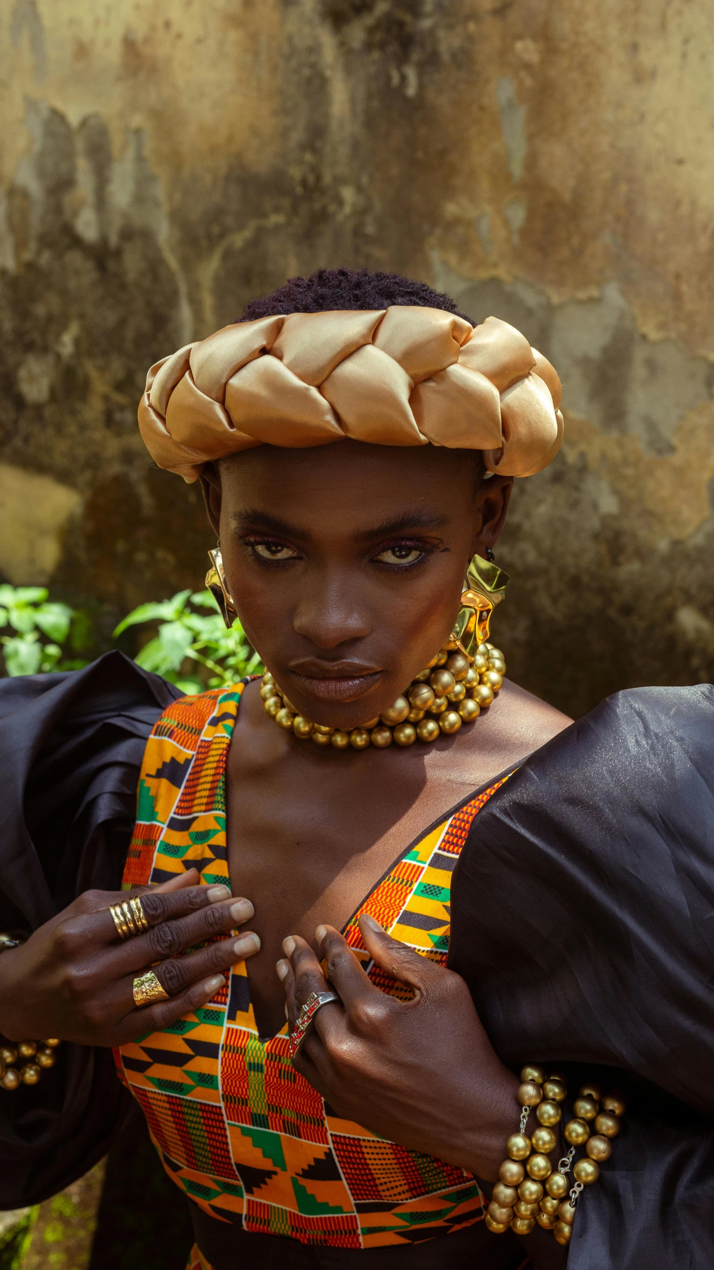 an african woman in a dress with beads and a head piece