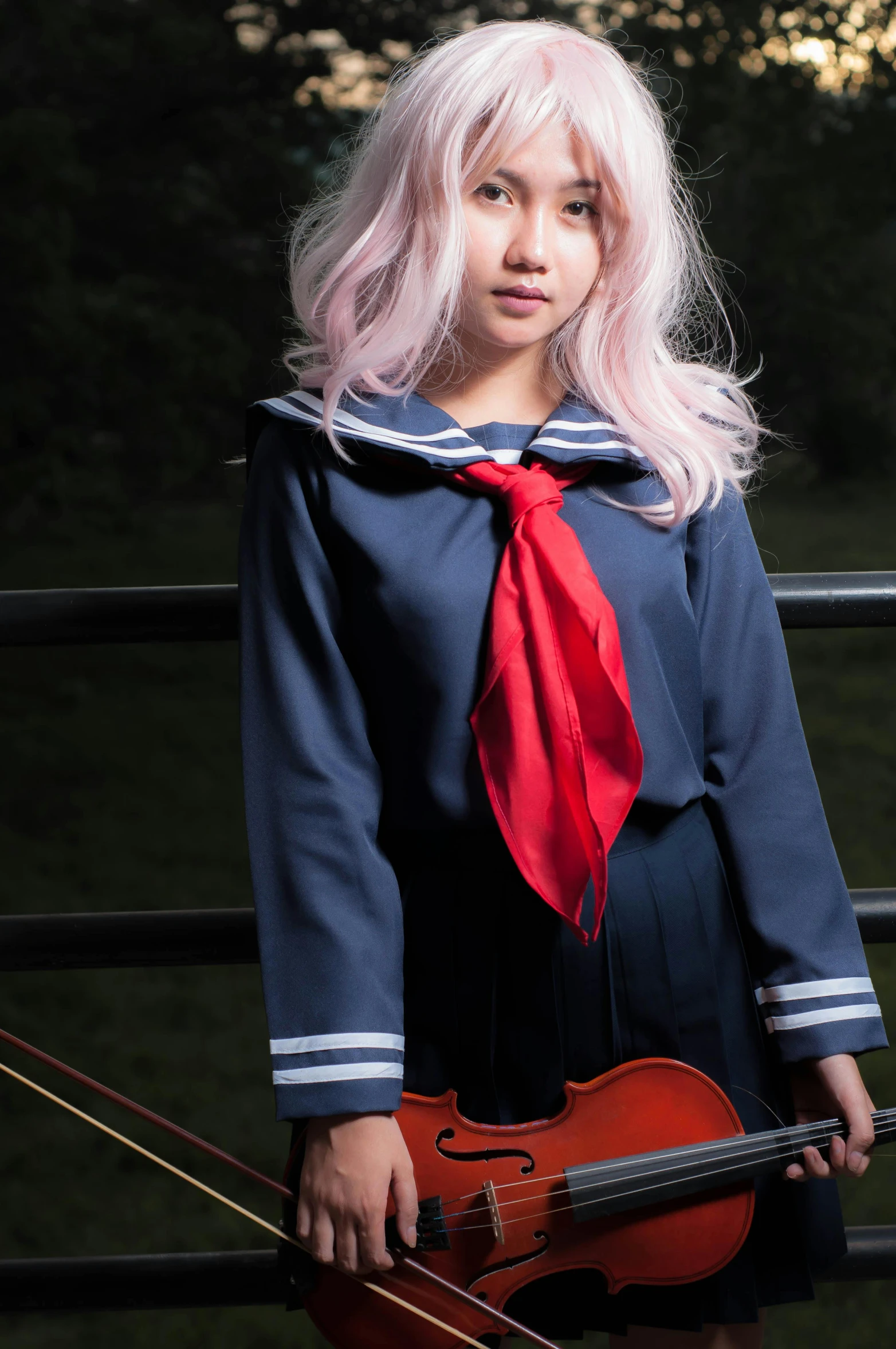 a girl with a pink hair, blue shirt and a red tie and violin