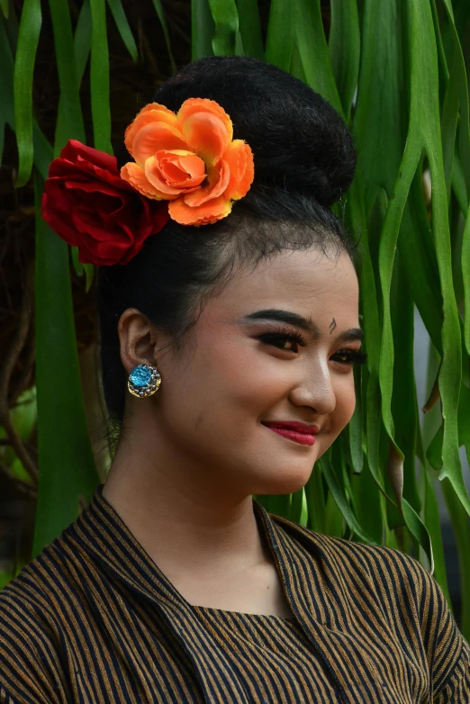 woman with a hair flower in her head smiling