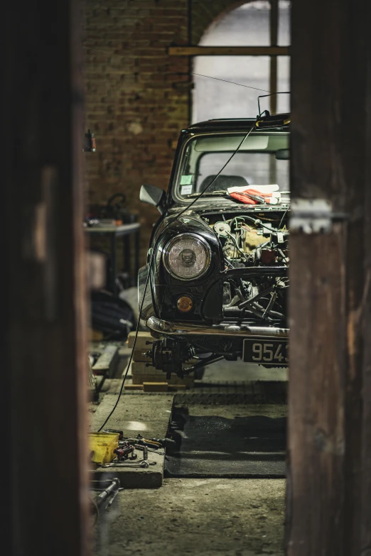 an old black car with a rusted hood