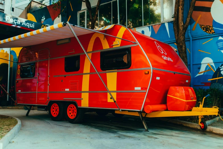 a red trailer is painted with stripes and red paint