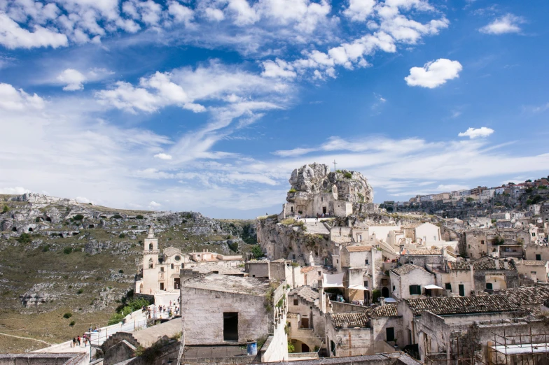 a scenic view of a city next to a big hill