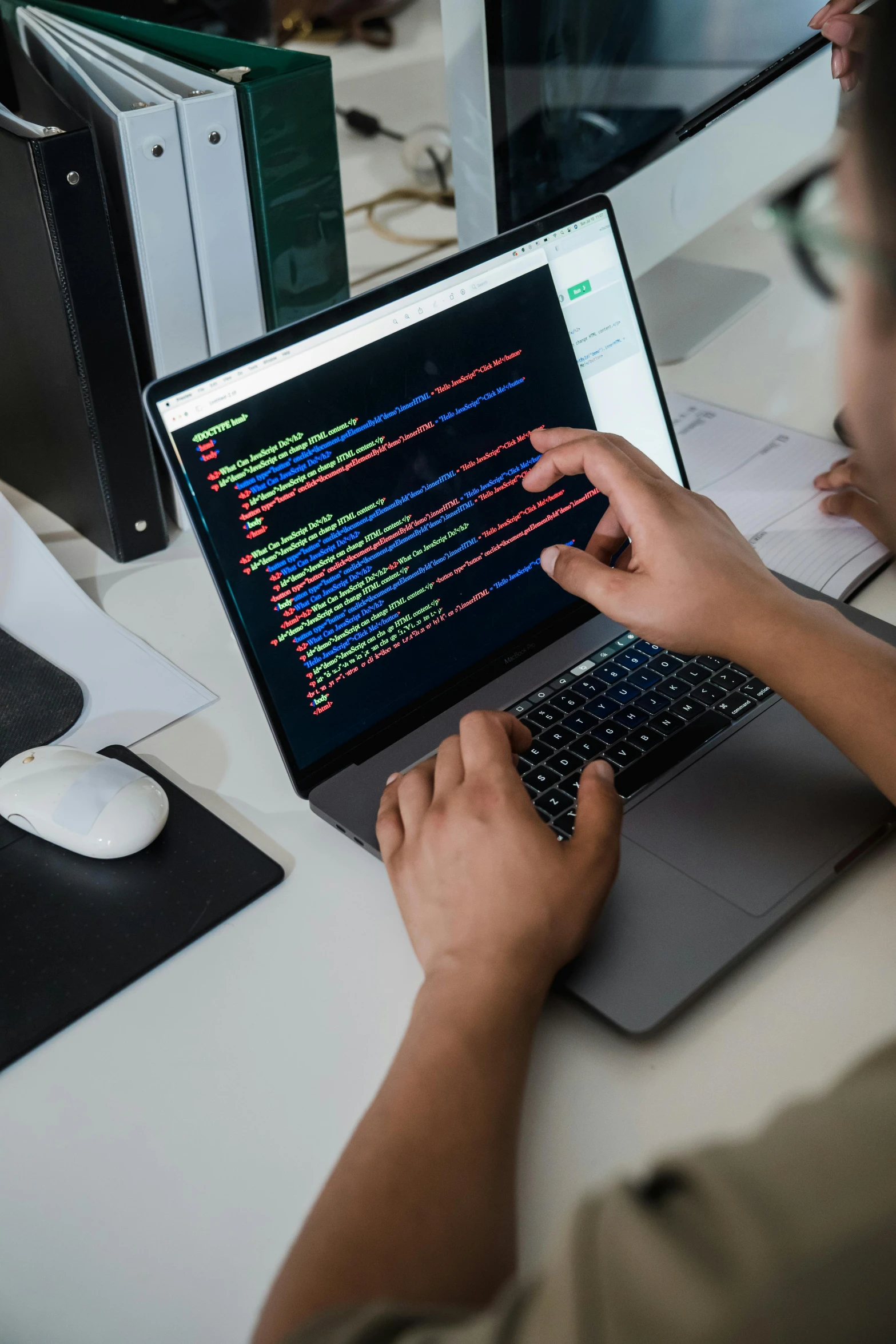 man on laptop displaying programming text on screen