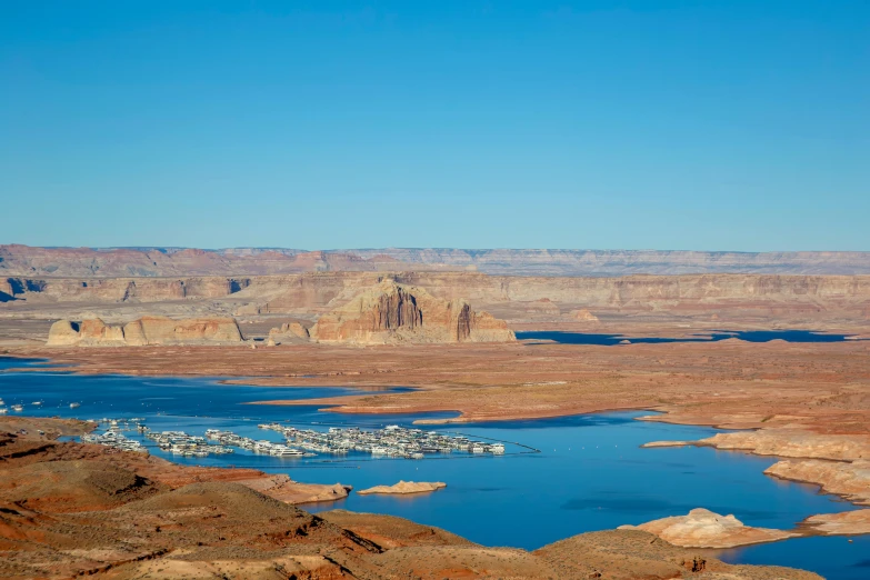 a large body of water near mountains and desert