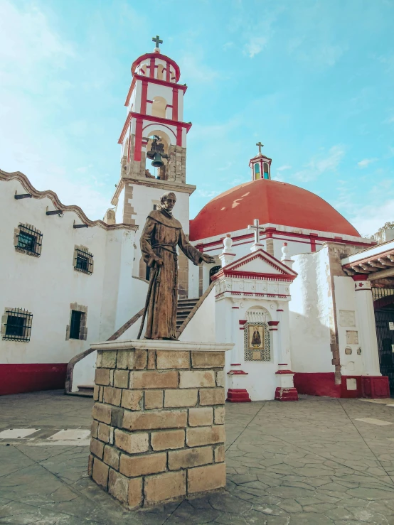 a stone and brick structure with a statue near it