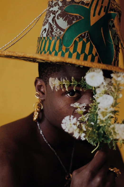 a man wearing a hat with flowers on it