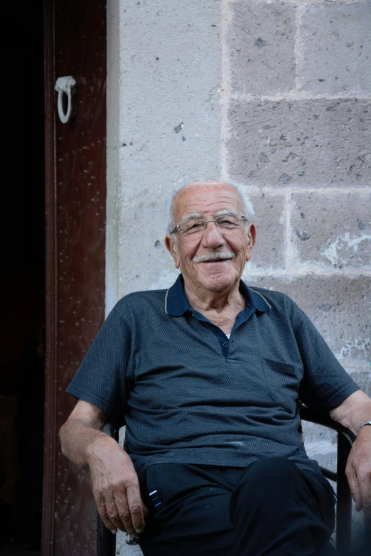 an older man sits down in his chair