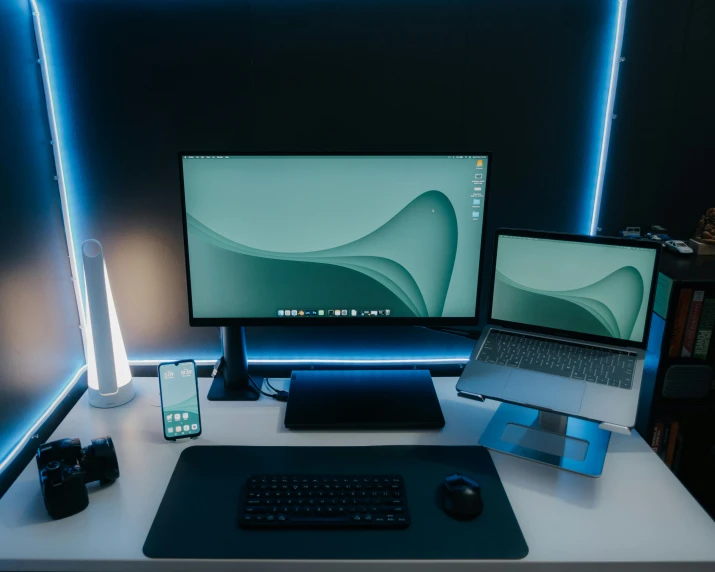 two monitors are sitting on top of a desk