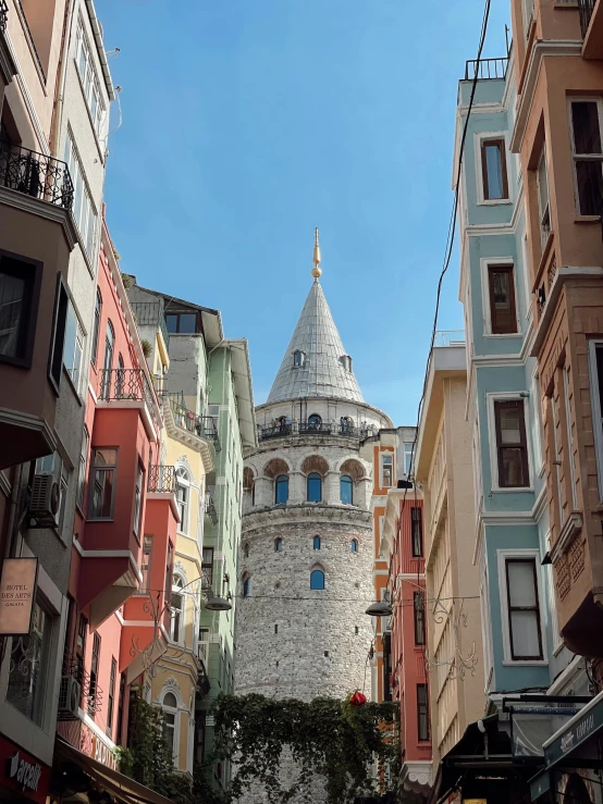 a group of buildings with a tower in the background