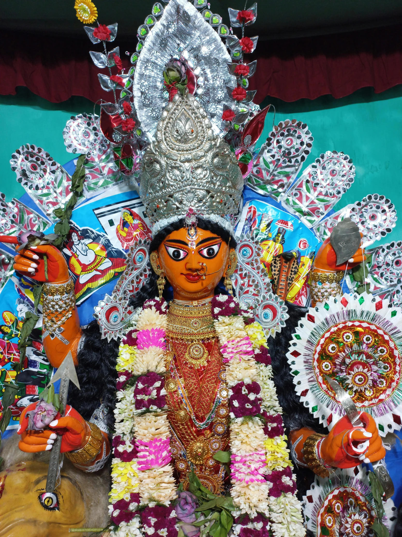 colorful statue of an indian goddess holding five round flowers