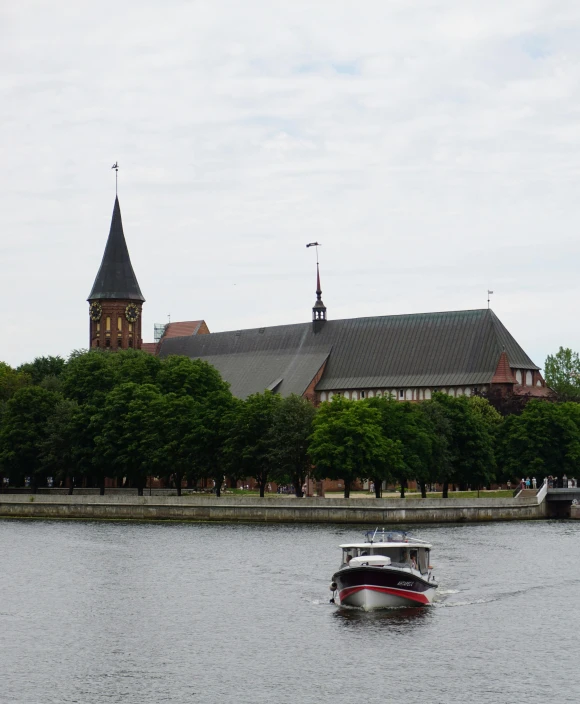 a boat on the water in front of a church