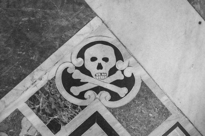black and white pograph of a skull and crossbones on the floor