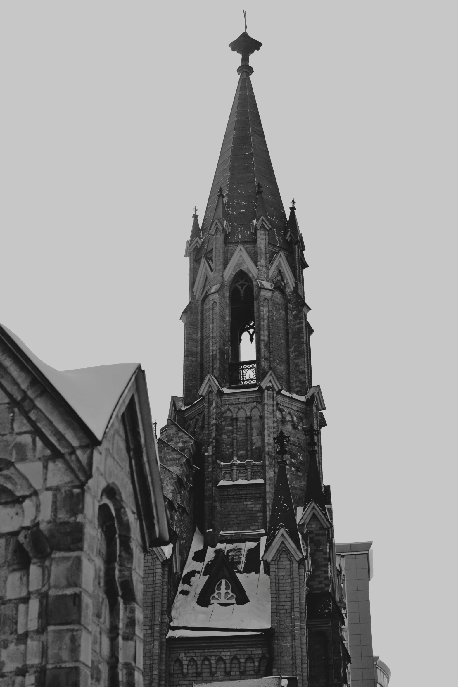 an old gothic cathedral with steeples on a snowy day