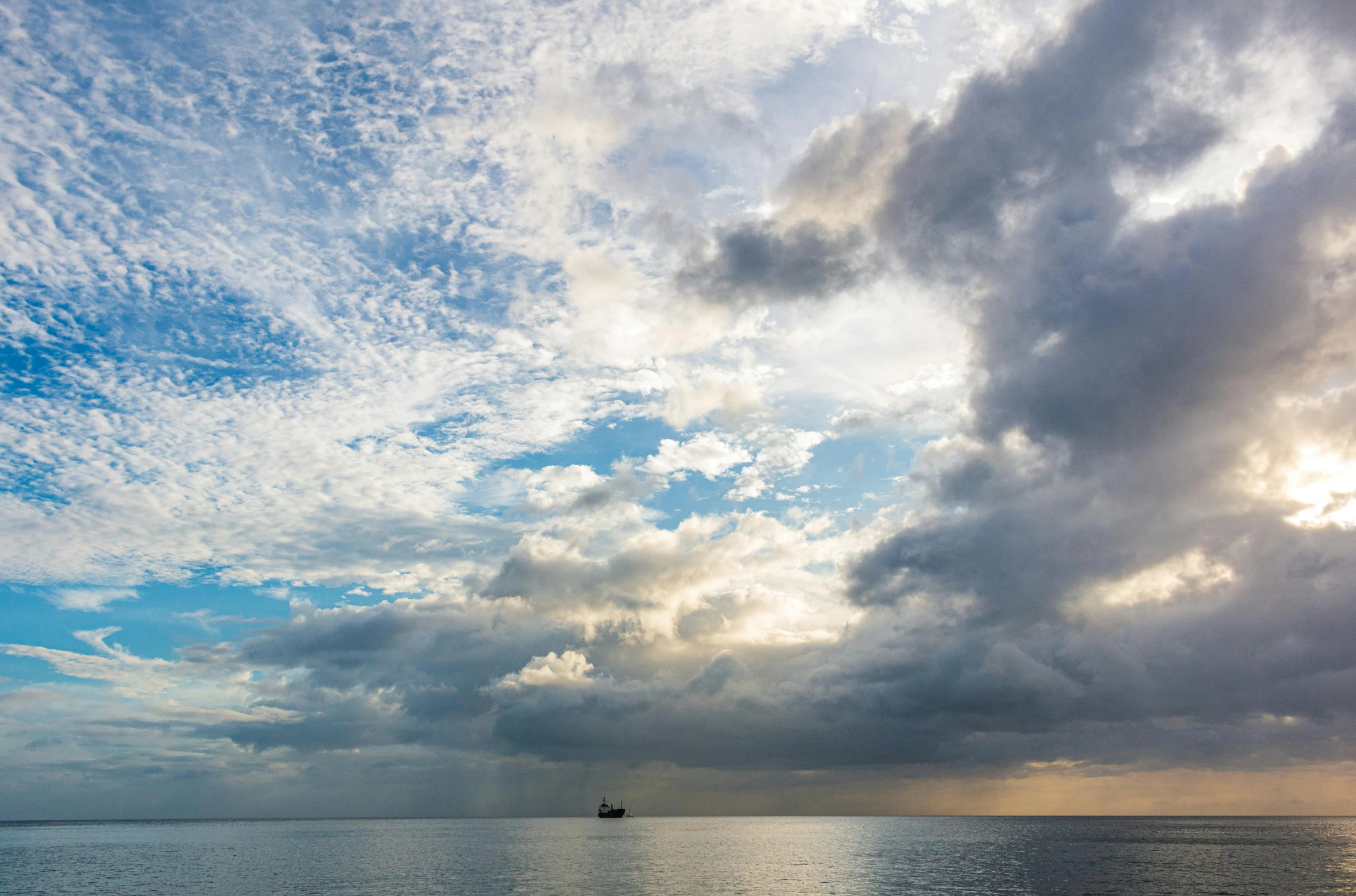 a view of the water with a boat at sunset