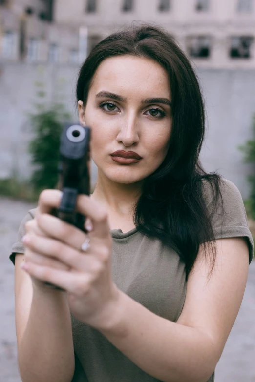 a woman holding a gun in her hand