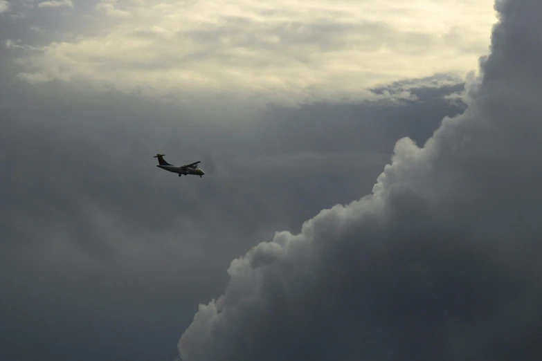 an airplane flying through dark cloudy skies