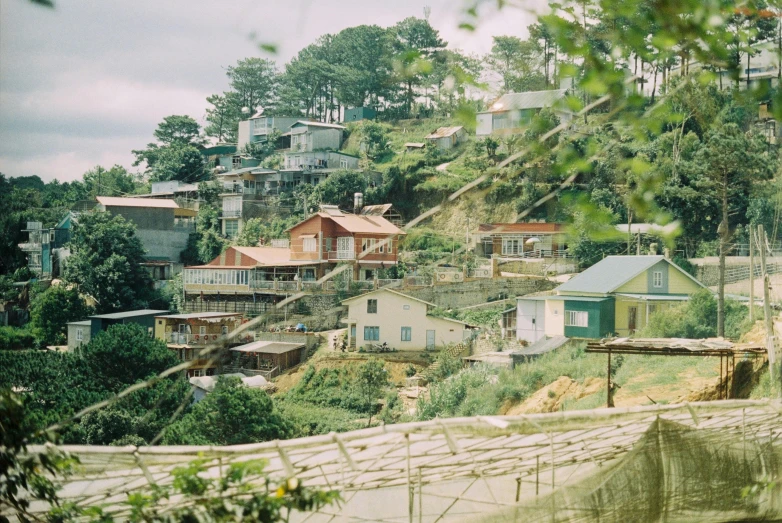 houses and a water fall near a hill side