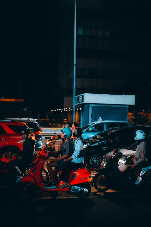 there are some motorcyclists that are at night together