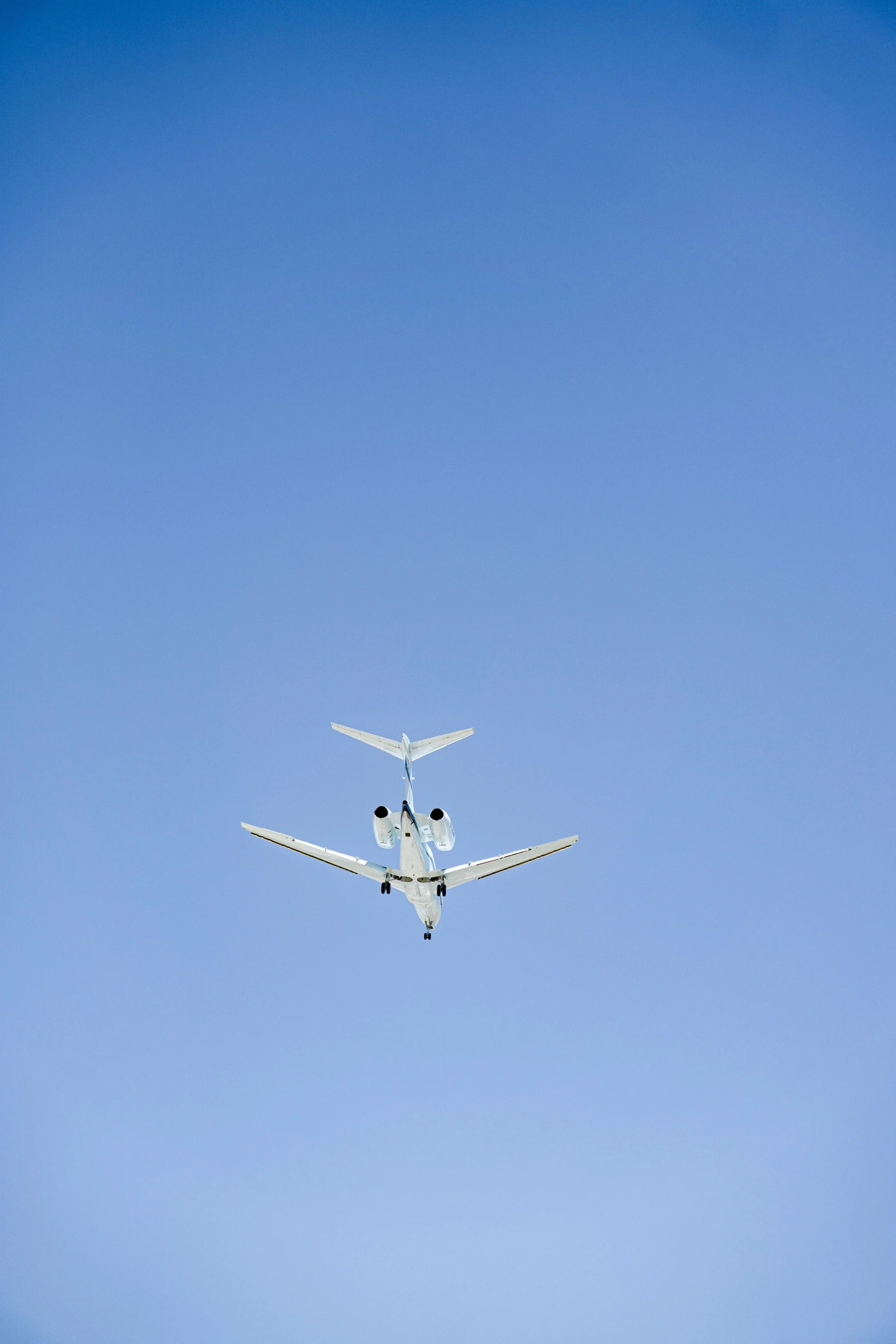 an airplane flying in a bright blue sky