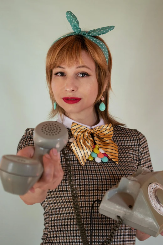 a woman wearing earbuds holding some type of hairdryer