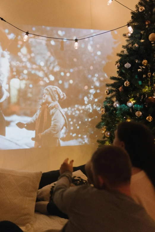 people watching an event in front of a tv screen