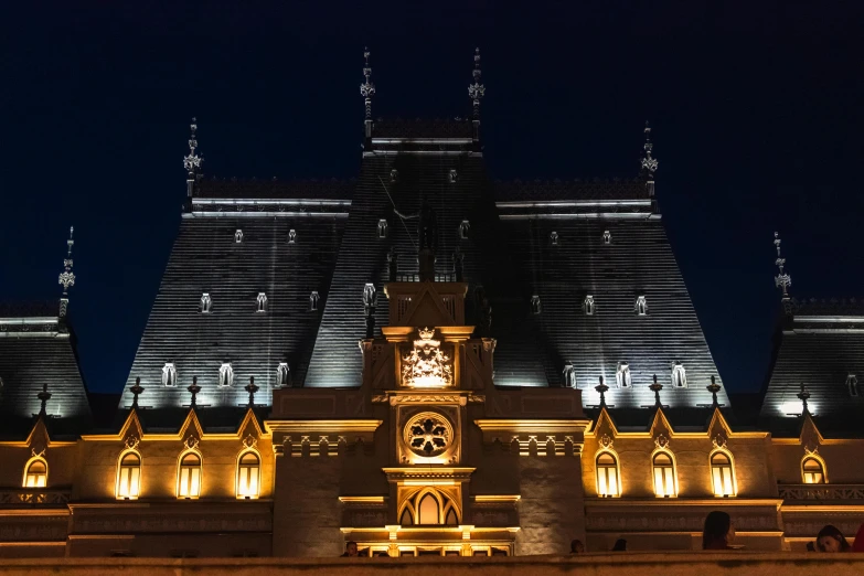 an architectural structure with two clock towers in the night