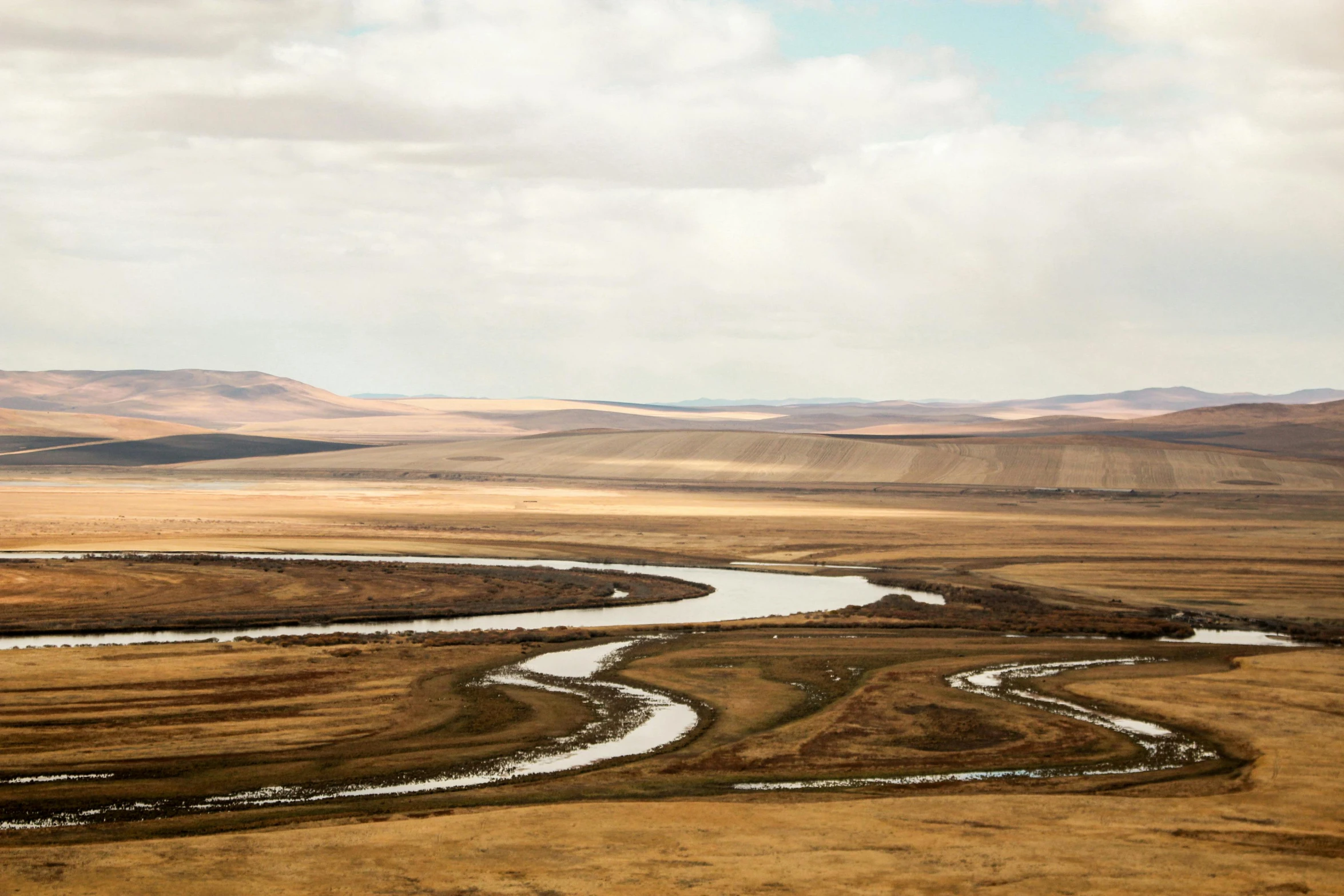 the river is flowing through the dry landscape