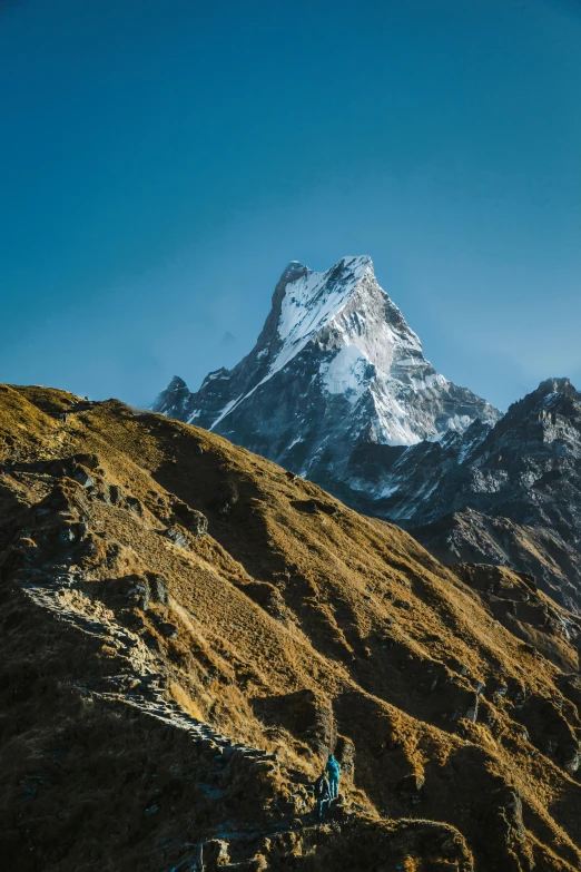 some mountain with people on it and trees below