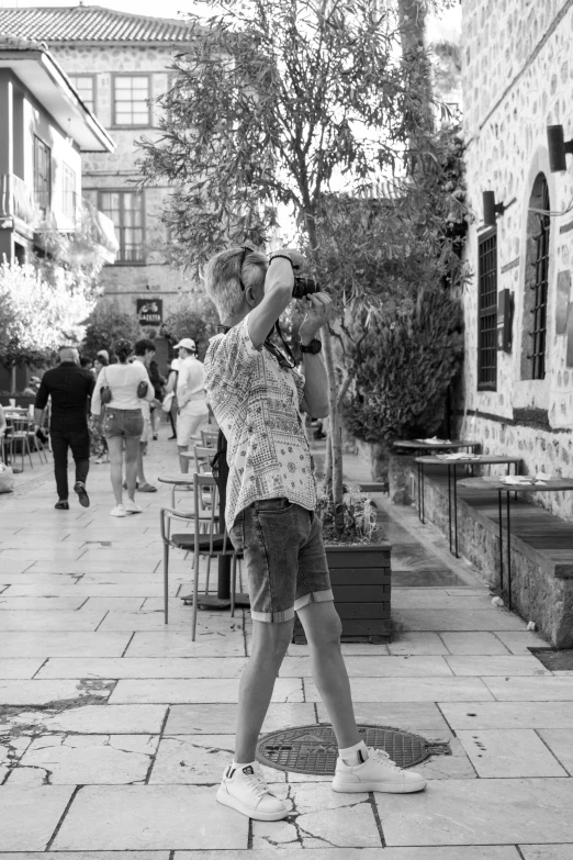 black and white image of a boy taking a po