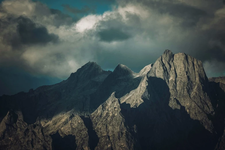 the clouds are forming above the mountains with a clear sky