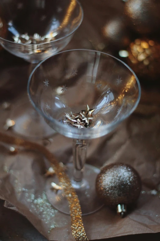 a glass filled with a liquid and a piece of paper next to it