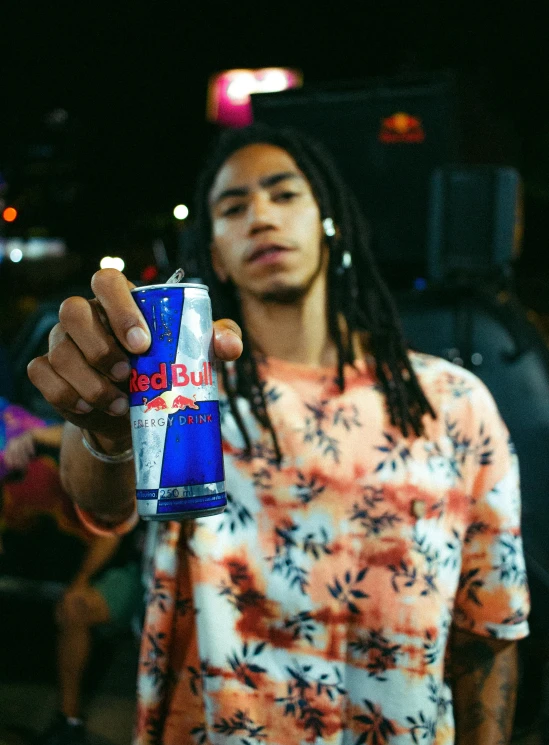 a man standing with a soda can on his arm