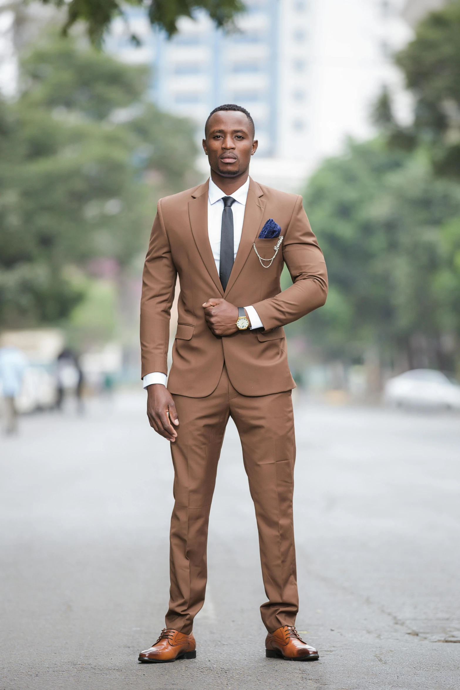 a young black man in a suit posing