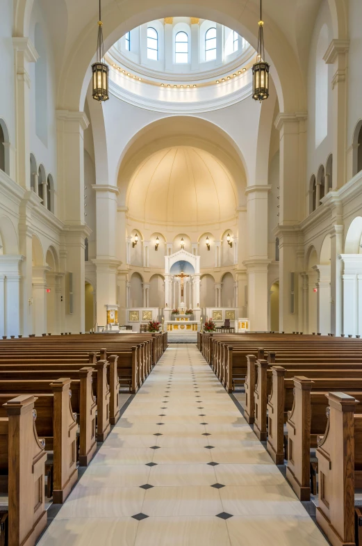 empty pews inside a large church during the day