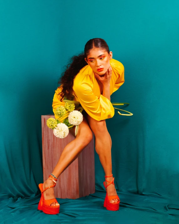 a girl is posing for a po in her yellow dress