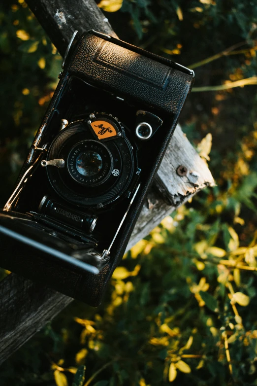 an old fashioned po on display on a wooden fence