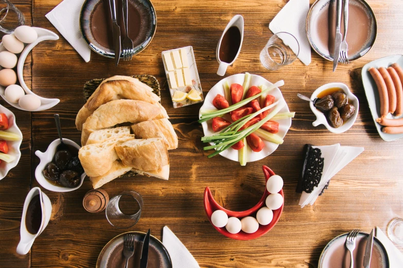 several foods on plates on top of a wooden table