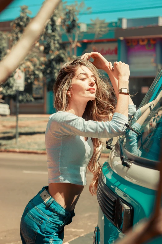 a woman leans on the car door to adjust her watch