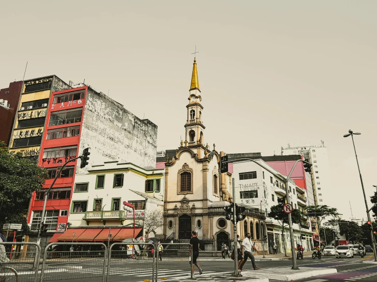 a white building with a golden spire at the top