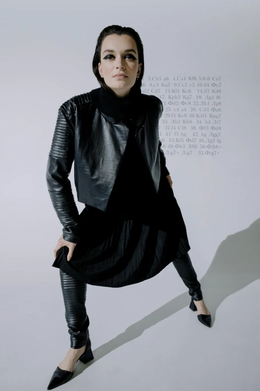 woman in leather coat posing for a po