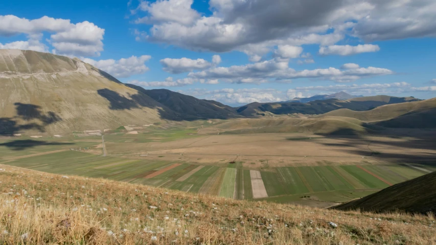 the view over a field on a partly cloudy day